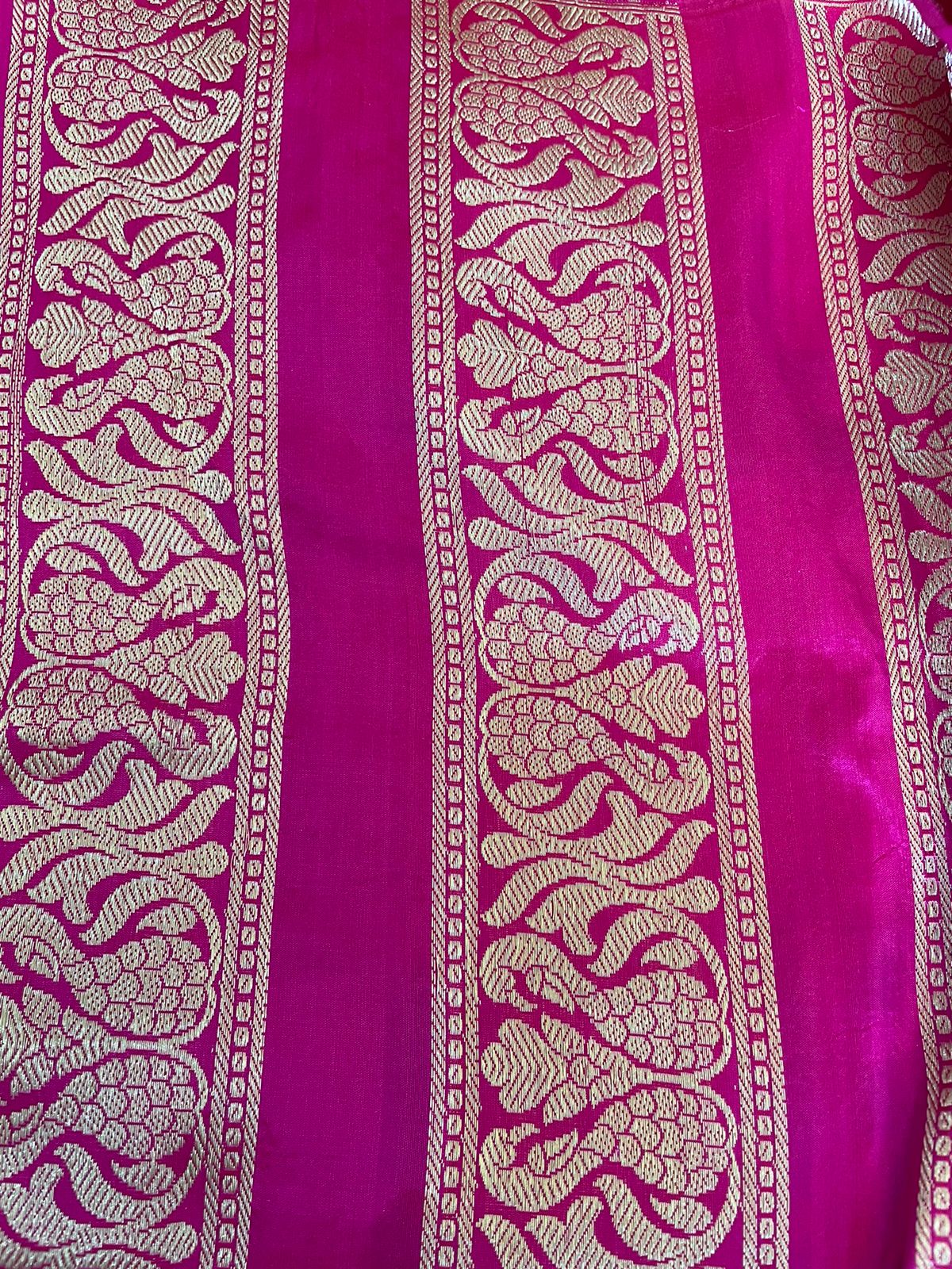 Pink fabric with intricate gold patterns